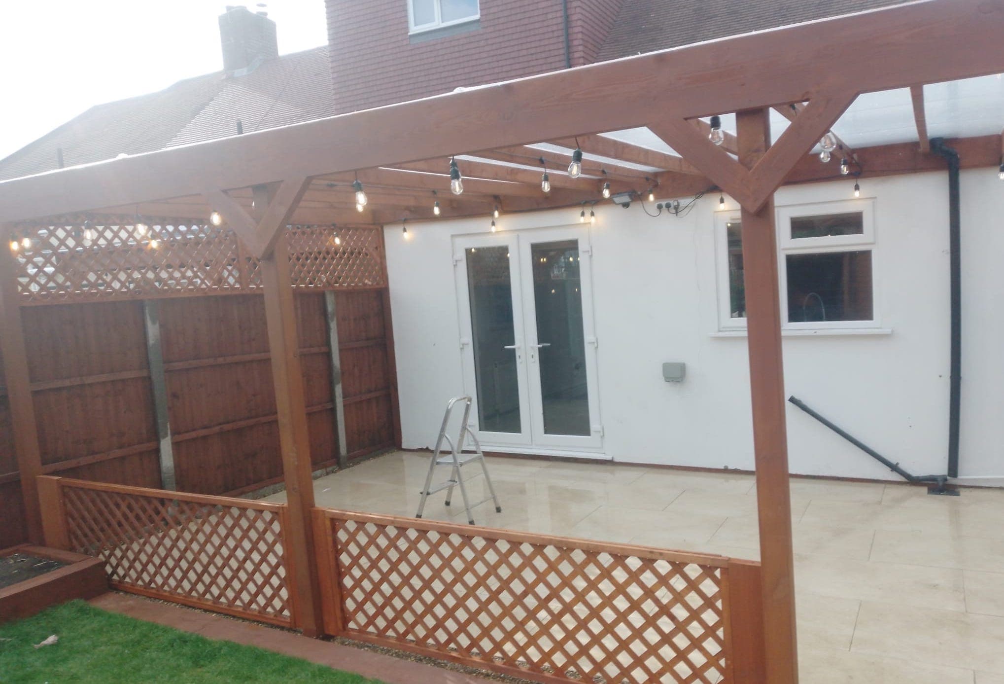Modern Wooden Pergola with Outdoor Lighting and Patio Installation